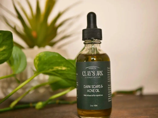 image of 2oz dropper oil with label and plants in background.